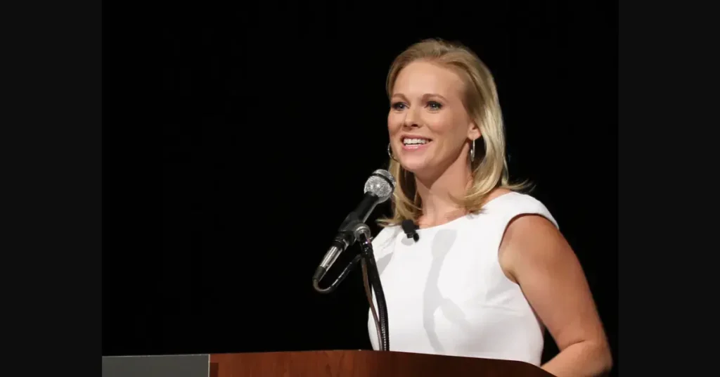 a woman standing at a podium with a microphone